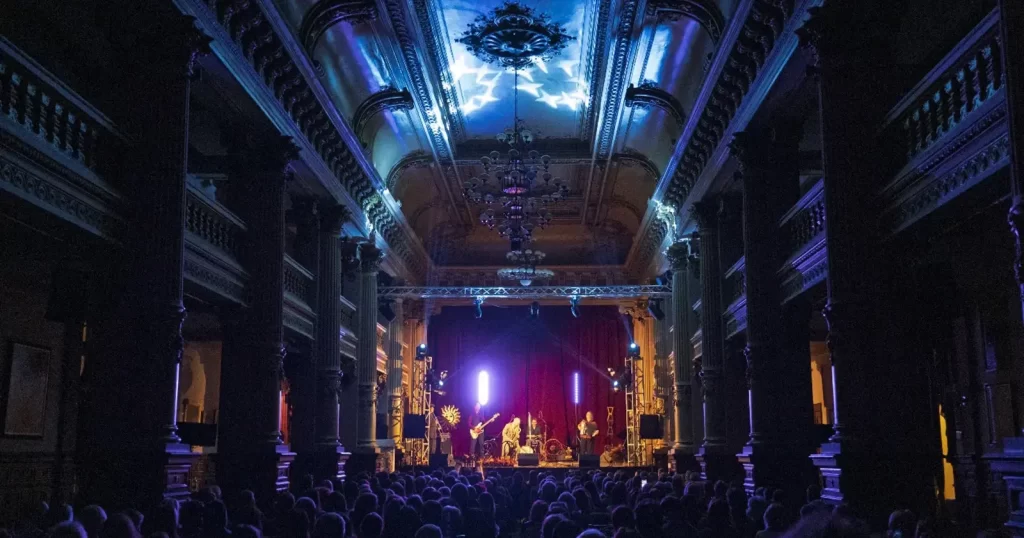 Festivalul SoNoRo 2026 - Concert SoNoRo într-o sală istorică iluminată în albastru, cu public numeros