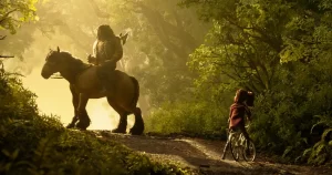 Wildwood: Tărâmul fantastic – călăreț și fată cu bicicletă într-o pădure fermecată